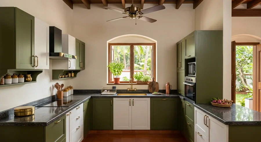 U shaped modular kitchen with lacquered glass shutters at a Guruvayur home